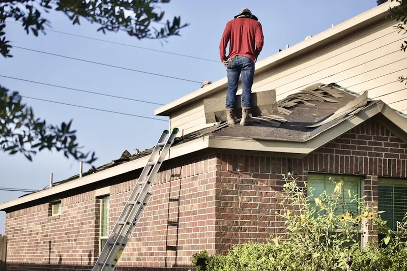 Professional roofer working on a residential roof in Sammamish Valley